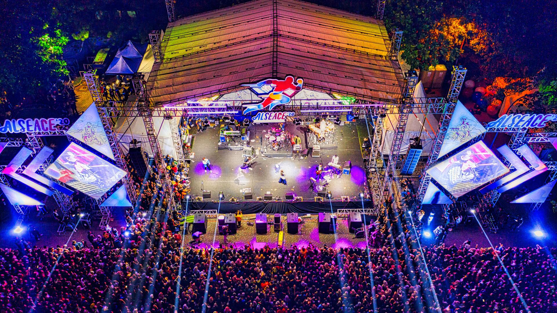 Outdoor night concert with professional stage lighting and crowd